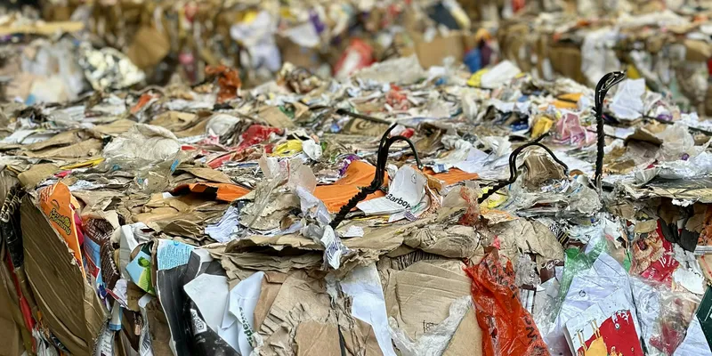 Baled recyclable material staged inside a processing facility