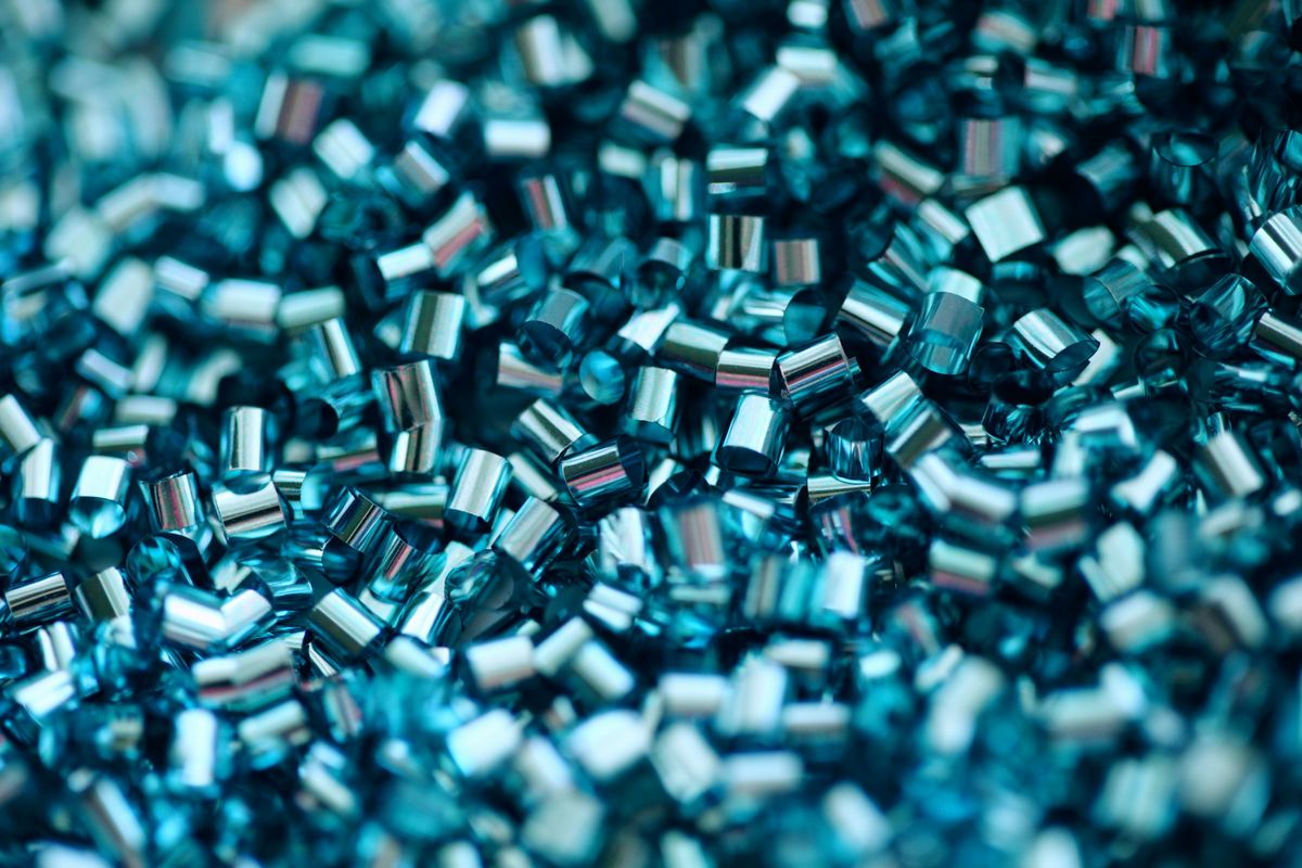 Close-up of QC-tested recycled plastic regrind pellets